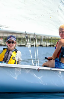 Two girls on a white sailboat