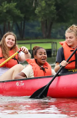 Three girls in a canoe at Day Camp