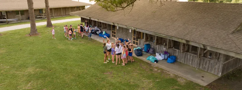 Aerial view of girls outside cabins