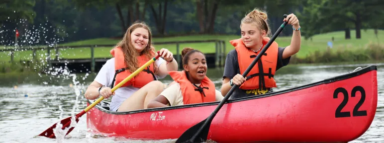 Three girls in a canoe at Day Camp