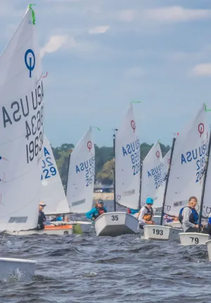 a group of optis sailing at Camp Sea Gull