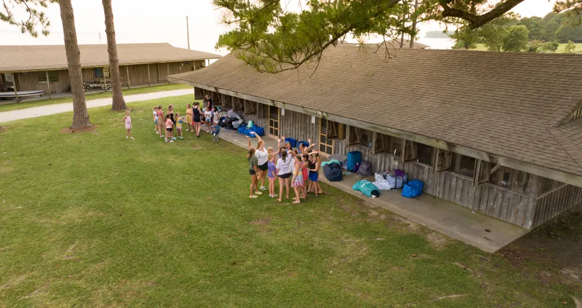 Aerial view of girls outside cabins