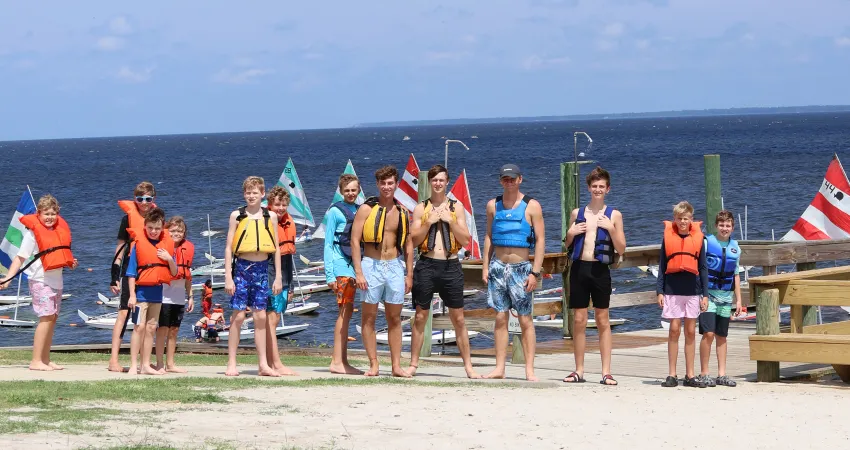 Campers and counselors lined up along the waterfront preparing for water activities