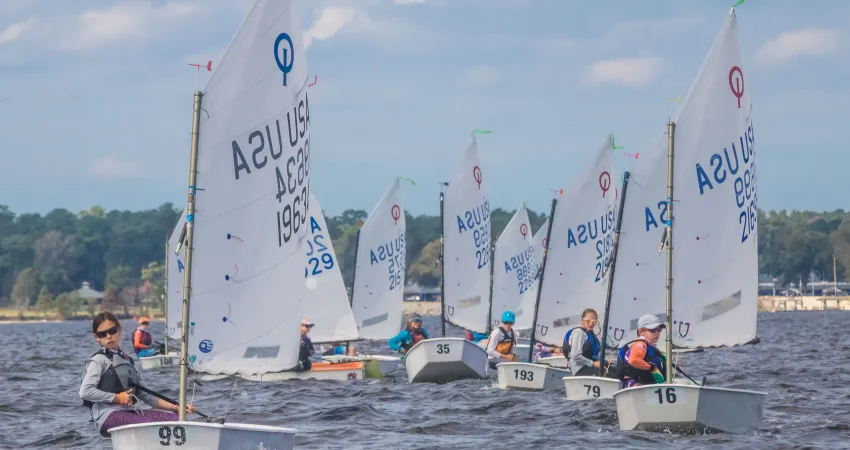 a group of optis sailing at Camp Sea Gull