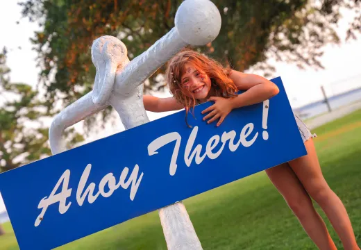 Girl standing by Ahoy There sign